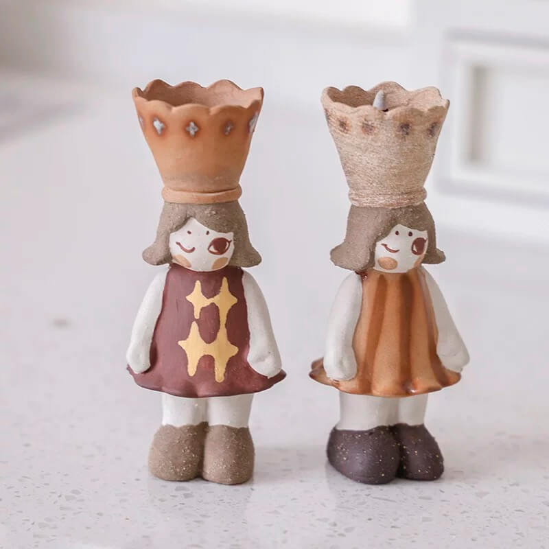 Two figurines side by side